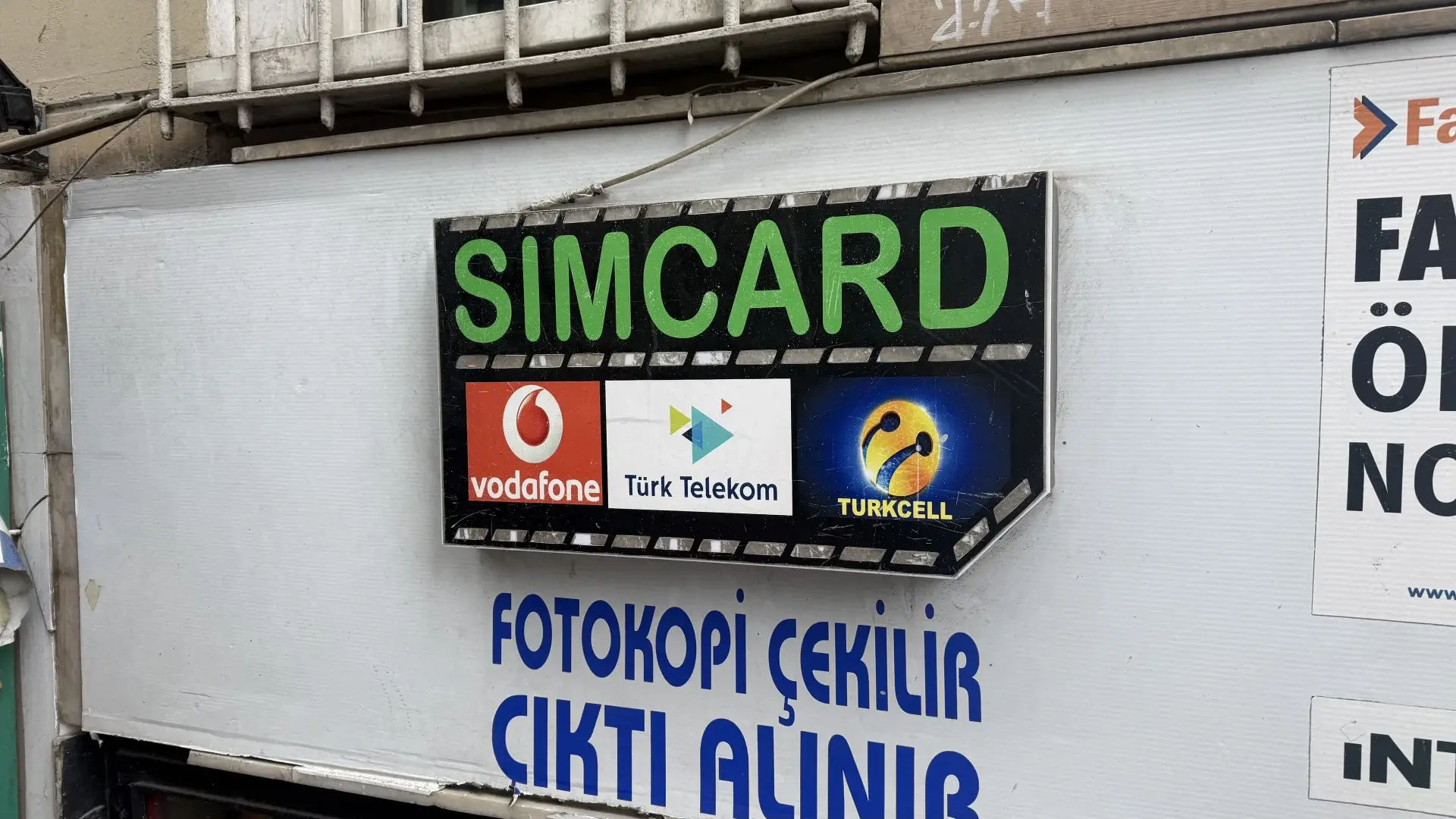 Sim card shop sign in Istanbul showing logos of the three Turkish mobile networks: Vodafone, Türk Telekom and Turkcell