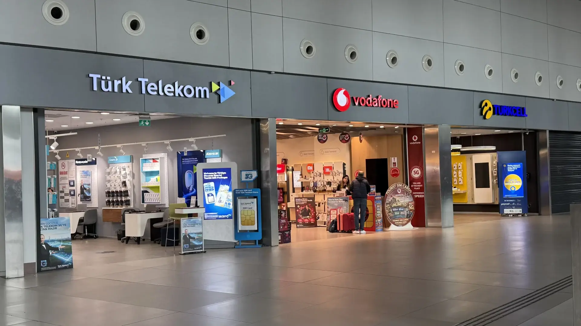 Official Türk Telekom, Vodafone and Turkcell shops side by side in the arrivals hall of Istanbul Airport, all selling tourist SIM cards